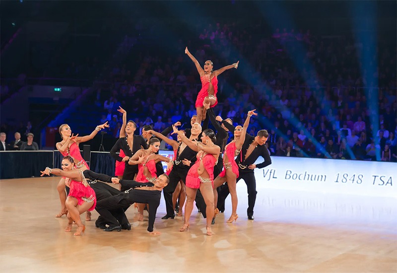 a group of people dancing on a stage