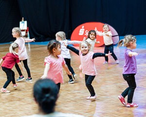 a group of children dancing in a dance studio